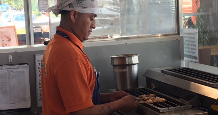 person grilling yakitori