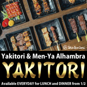Yakitori skewers such as sausage, pork belly, beef, negima and skin on the small black plates on the wood table, black box on the bottom and there are white letter say "Yakitori & Men-Ya Alhambra" and gold brush letters say "YAKITORI" under there letters, small white letters say"Available EVERYDAY for LUNCH and DINNER from1/2"