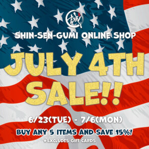 Promotional graphic for the Shin-Sen-Gumi Online Shop July 4th Sale. An American flag fills the background with large gold glitter text reading "JULY 4TH SALE!!" The sale runs from June 23 through July 6. Customers receive 15% off when purchasing five any items. Gift cards are excluded from the promotion.